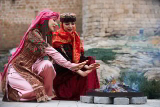 Beautiful Azeri Women in Traditional Azerbaijanz Dress Warming Hands Above the Bonfire Beautiful Azeri Women in Traditional Azerbaijanz Dress Warming Hands Above the Bonfire