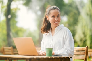 Handsome Young Woman Enjoys Working Outdoors At A Cafe Terrace In A Park Handsome Young Woman Enjoys Working Outdoors At A Cafe Terrace In A Park