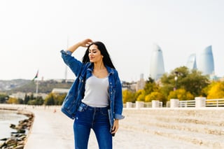 happy stylish fashionable woman posing against stairs background happy stylish fashionable woman posing against stairs background