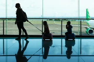 In Airport Transit Hall Young Mother Carries On Suitcases Little Kids To Departure Gate For In Airport Transit Hall Young Mother Carries On Suitcases Little Kids To Departure Gate For