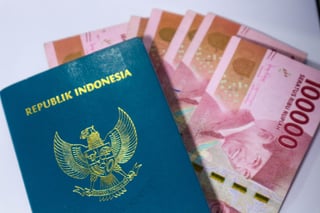 Indonesian Green Passport With A Collection Of Hundred Thousand Rupiah As The Background Indonesian Green Passport With A Collection Of Hundred Thousand Rupiah As The Background